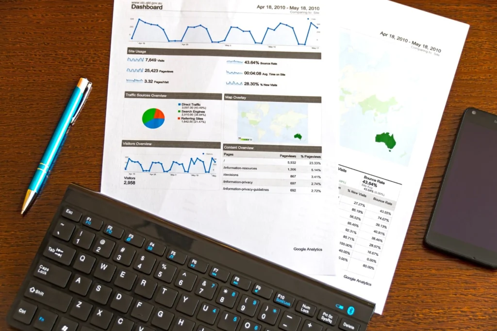 Blue Click Pen Near White Document Papers On Top Of Brown Wooden Table